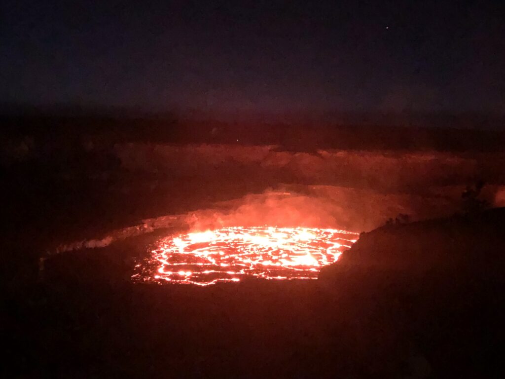 Glowing lava lake, with brilliant lines of incandescent red split by black